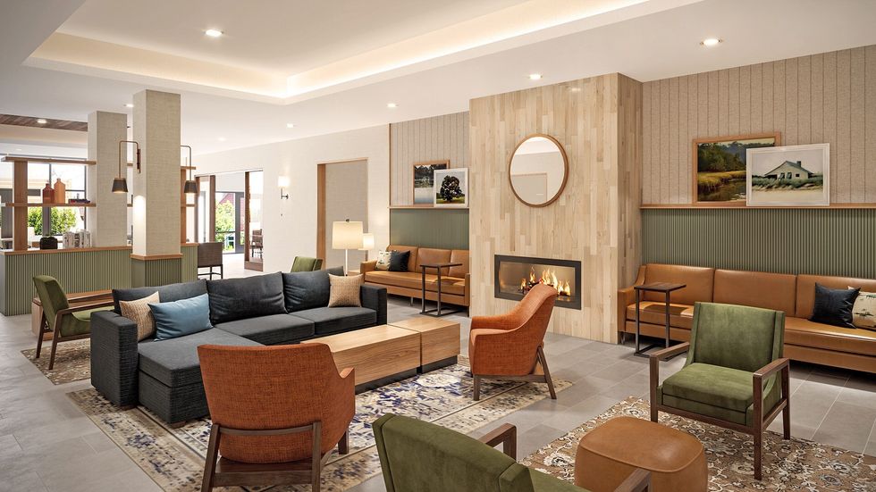 Country Inn & Suites modern lobby with fireplace and cozy seating by Choice Hotels