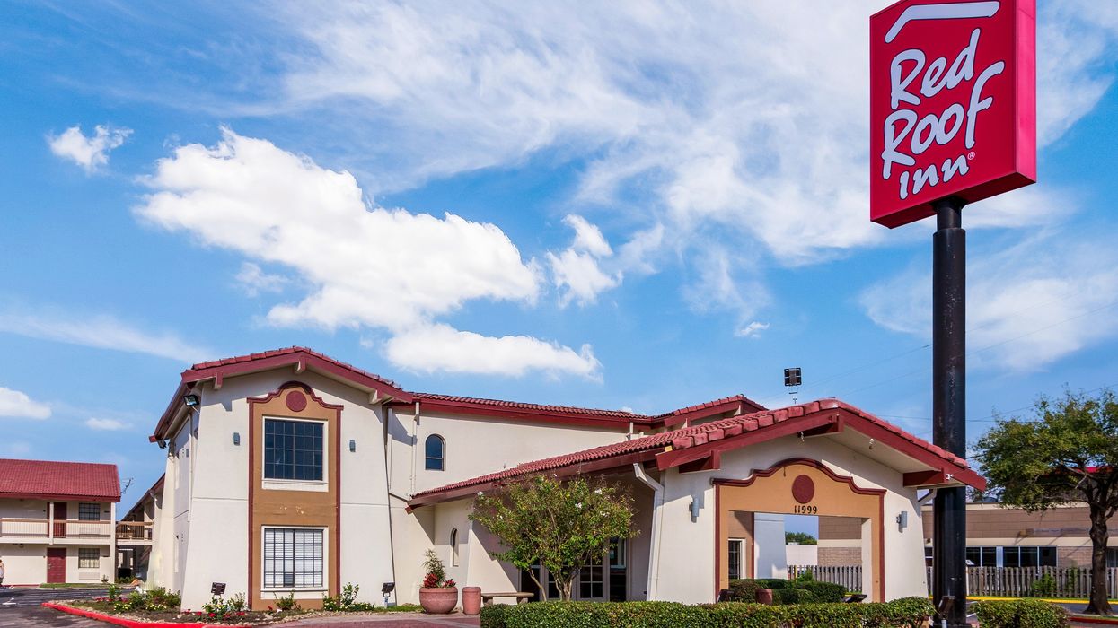 Exterior of a Red Roof Inn hotel with a prominent red sign, showcasing the brand’s presence in 2025, aligned with its HotelIQ AI revenue platform partnership.