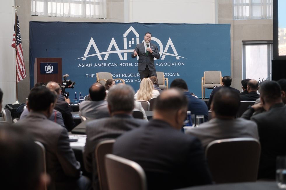 Rep. Aaron Bean at AAHOA SNAC 2025 podium urging SBA loan limit hike