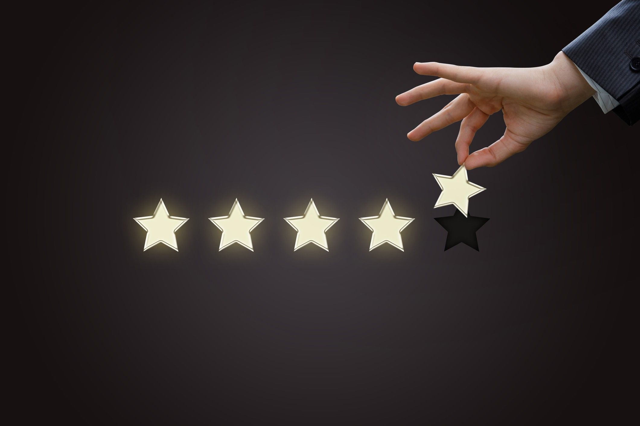 Hand of a businessman holding the fifth star.