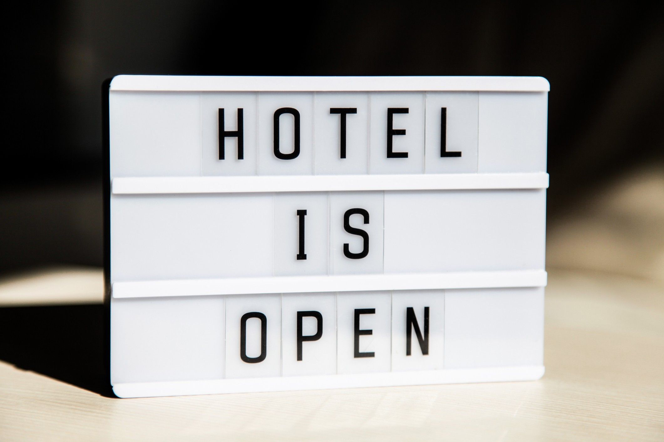 White lightbox with greeting text message Hotel is open. End of quarantine concept.
