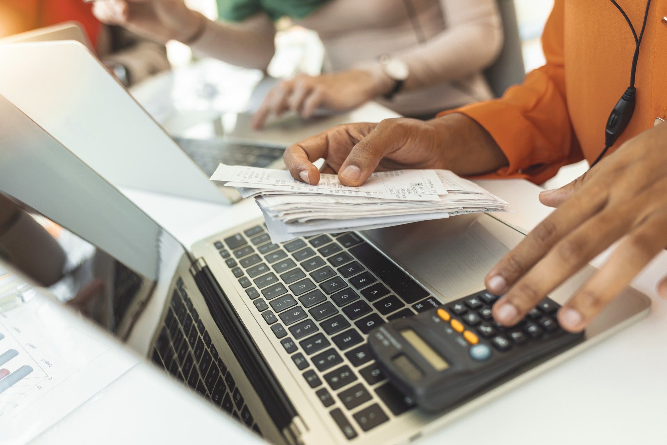 Person paying invoice to computer
