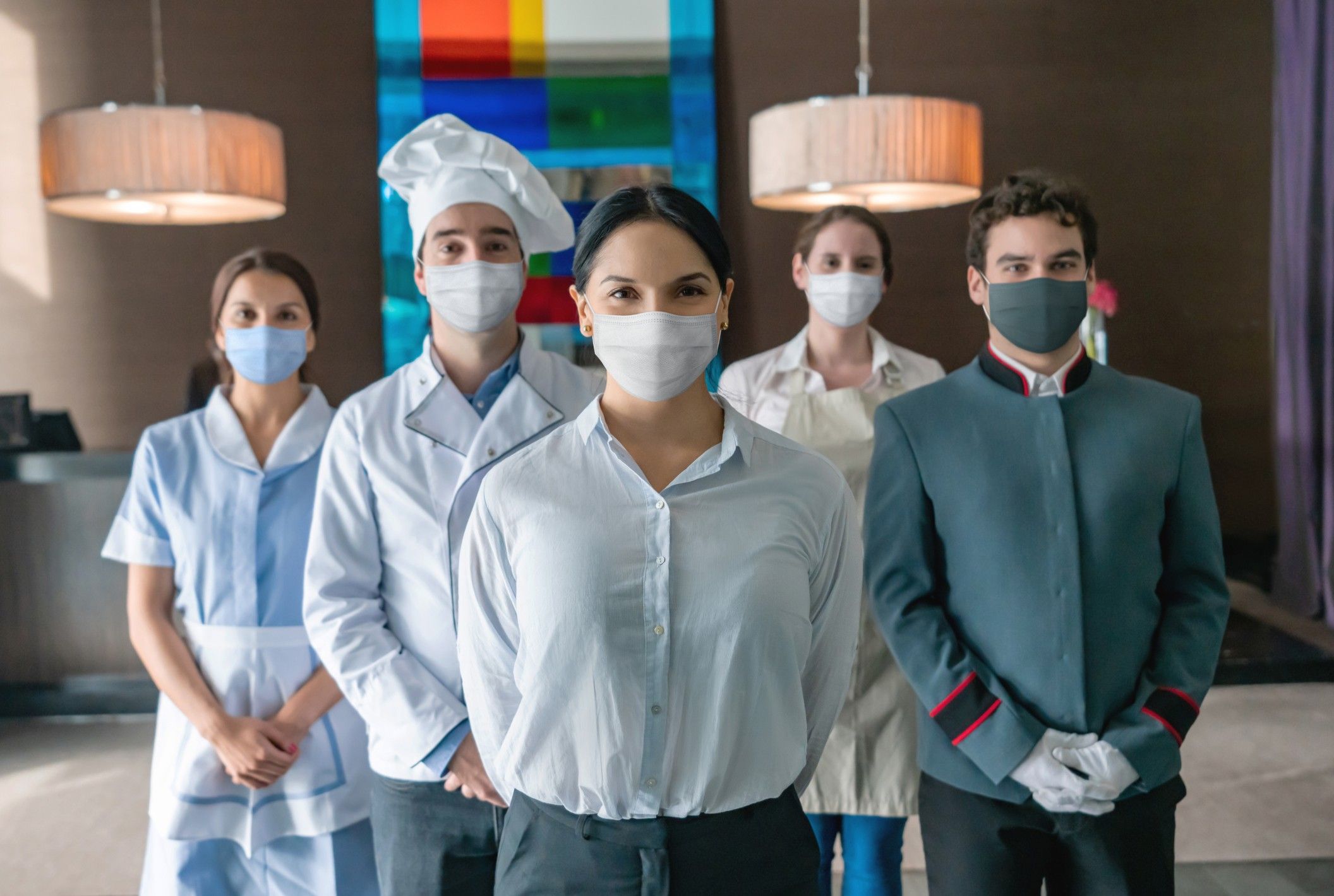 Staff at a hotel wearing facemasks during the pandemic