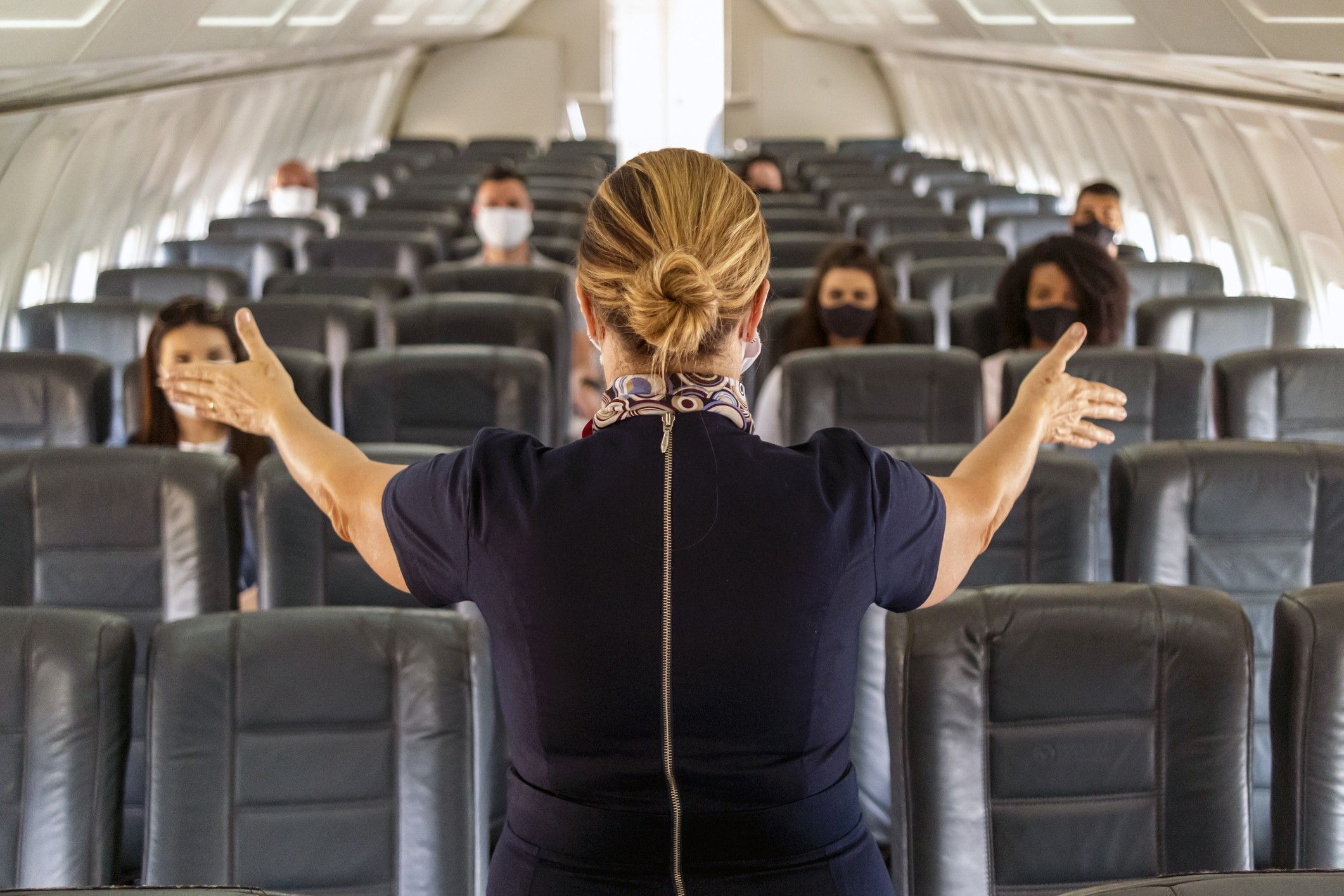 Flight attendant inside an aircraft. WYNDHAM HOTELS